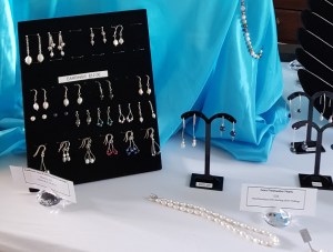 Detail of Marmalade Emma's stall showing earring board & pearl necklaces